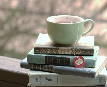 photo showing a tea cup on top of a stack of books