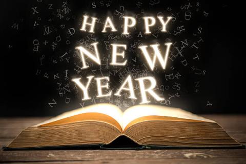 Happy New Year over an open book
